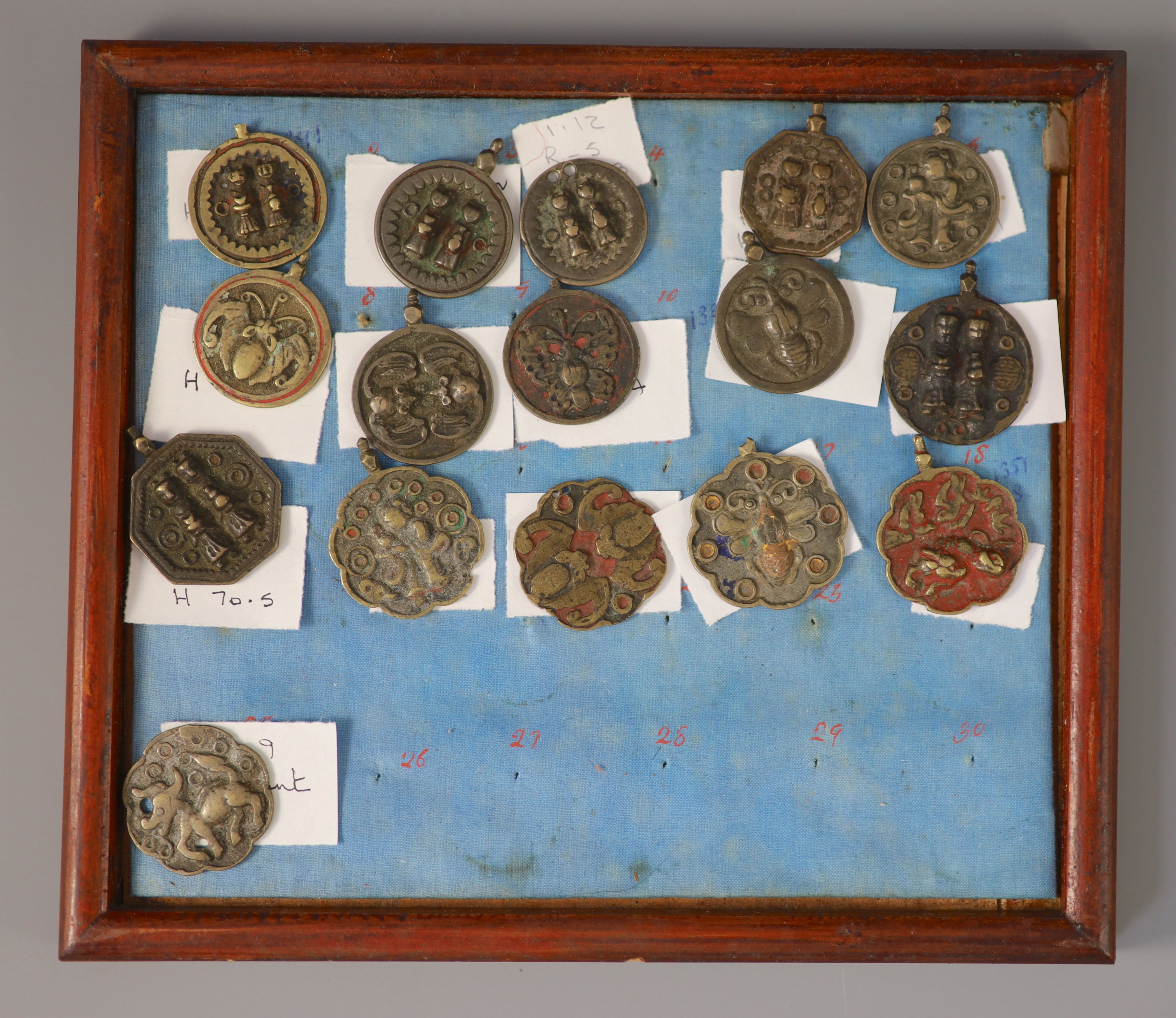 A group of 99 Korean bronze and metal amulets or charms, 19th/20th century